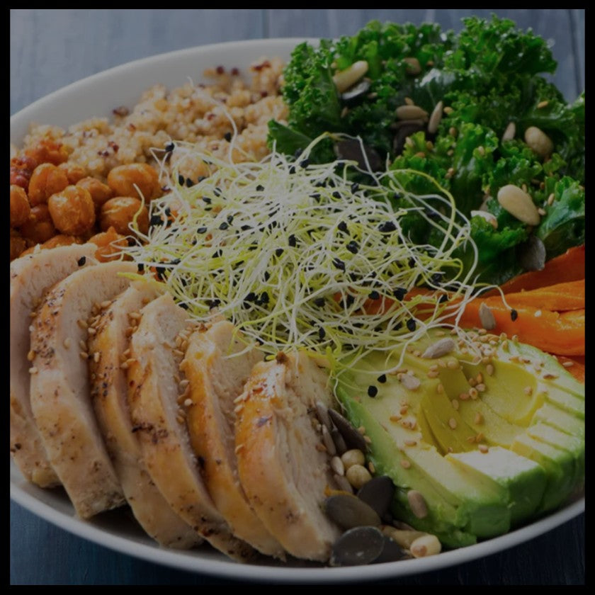 a healthy plate of food that includes chicken, avocado, chickpeas, kale and carrot