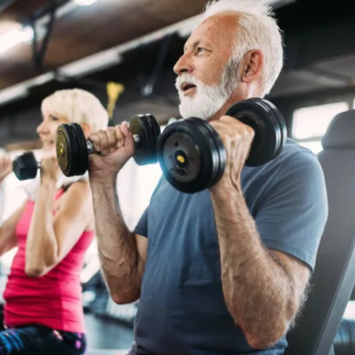 an old man with white hair lifting weights in the gym